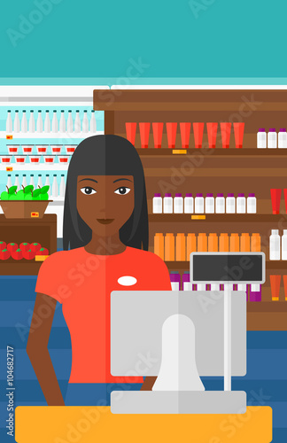 Saleslady standing at checkout.