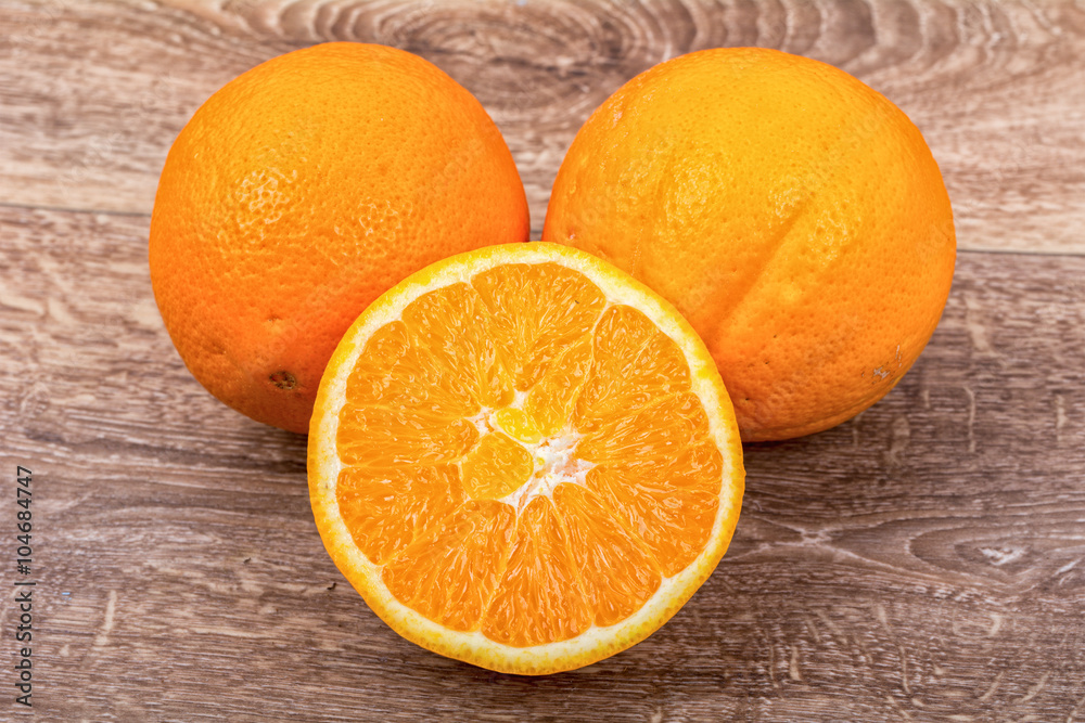 The orange oranges on a wooden background The orange oranges on a wooden background