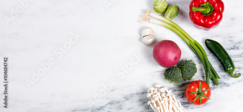 Fresh whole vegetables and fruit on natural white marble 