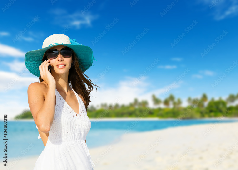Young woman with mobile phone on a beach Young woman with mobile phone on a beach