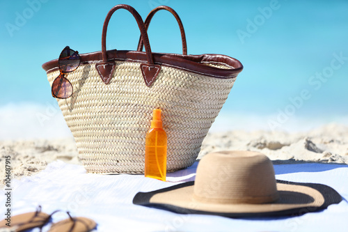 Beach bag and hat, sunglasses and sunscreen lotion