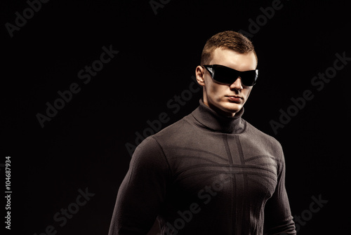 Valokuva Combat muscled action hero man wearing shirt with pants and sunglasses