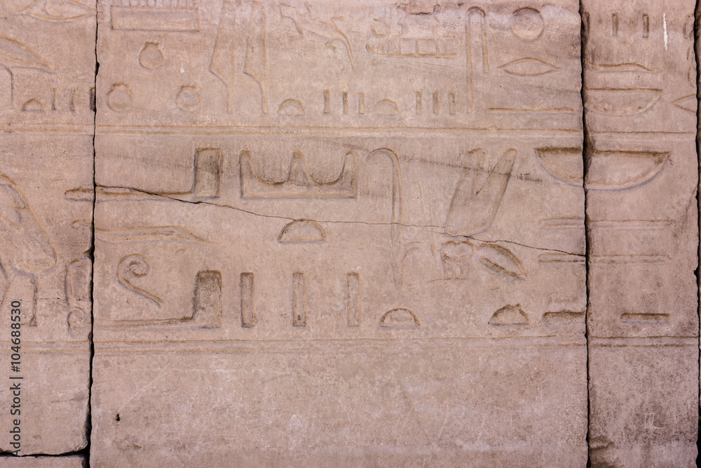 Egyptian hieroglyphs. Hieroglyphic carvings on a wall Egyptian hieroglyphs. Hieroglyphic carvings on a wall
