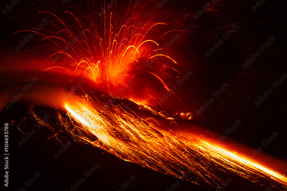 A close-up of a nocturnal volcano eruption at night, with lava exploding from Stromboli, creating a disaster and a panoramic view of the earth shaking.