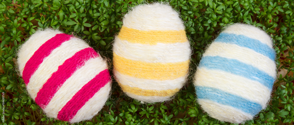 Easter eggs wrapped woolen string and green cress, decoration for Easter Easter eggs wrapped woolen string and green cress, decoration for Easter