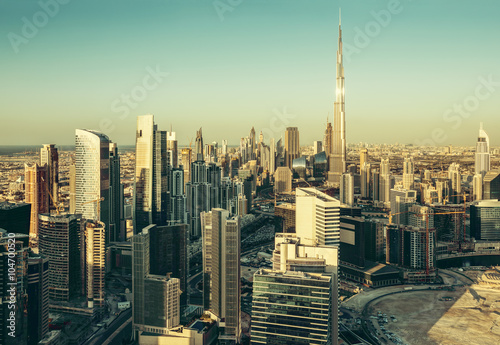 Beautiful architectural background. Panorama view of Dubai s business bay towers at sunset.