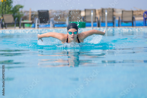 Young girl swimming butterfly stroke style