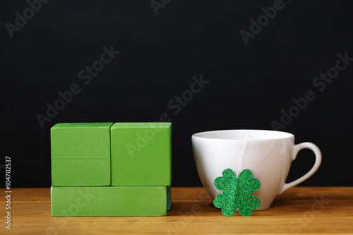 Green clover with white coffee cup
