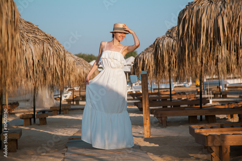 Young woman  walking by the beacn photo