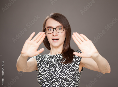 Young woman showing repulsive gesture