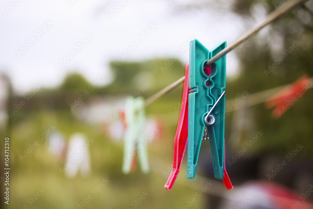 Plastic clothespin hanging on a rope