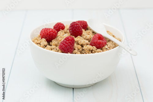 Granola in a bowl with raspberries, muesli