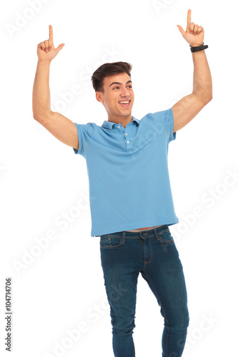 man celebrating with both hands raised