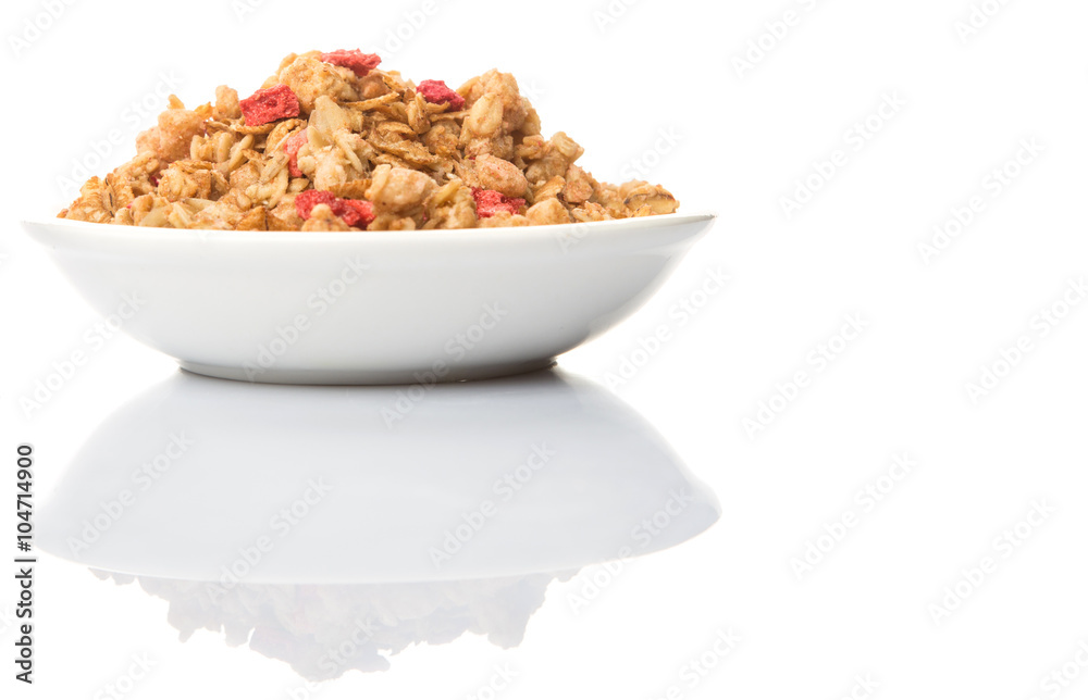 Breakfast cereal with dried raspberry fruit pieces in white bowl over white background Breakfast cereal with dried raspberry fruit pieces in white bowl over white background