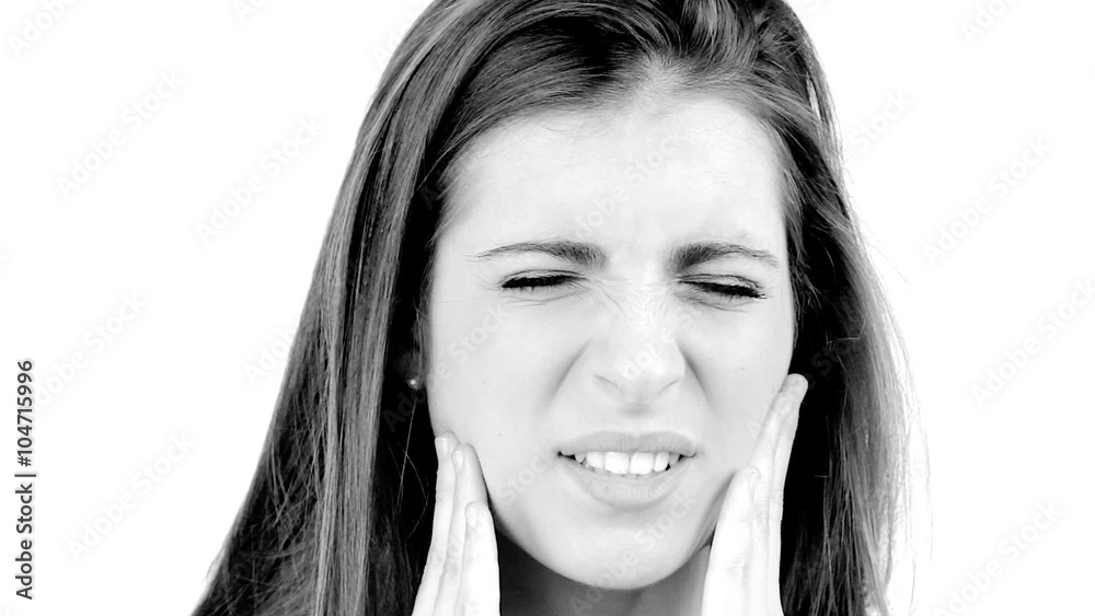 Young beautiful woman with strong teeth problem suffering closeup isolated Young beautiful woman with strong teeth problem suffering closeup isolated