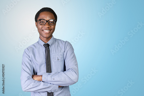 Portrait of happy young african guy with his arms crossed