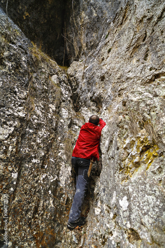 Caucasian man with backpack hiking into the mountains