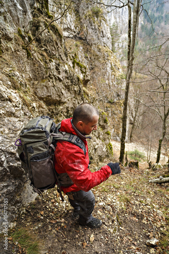 Caucasian man with backpack hiking into the mountains
