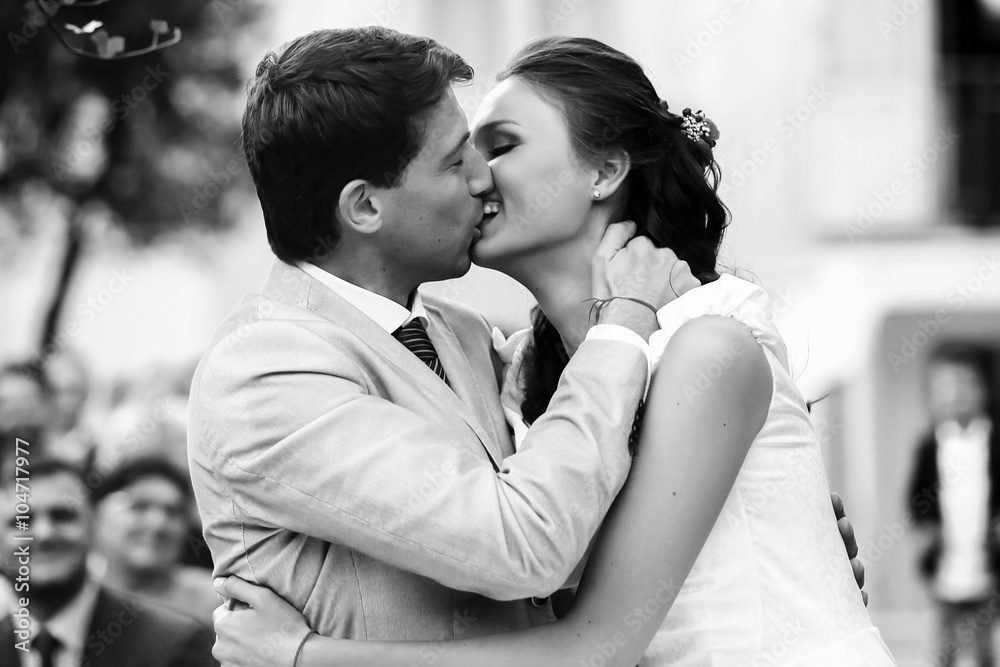 rich stylish groom and bride kissing near the arch of sunflower rich stylish groom and bride kissing near the arch of sunflower