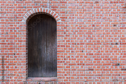 Old brick wall with wooden door.