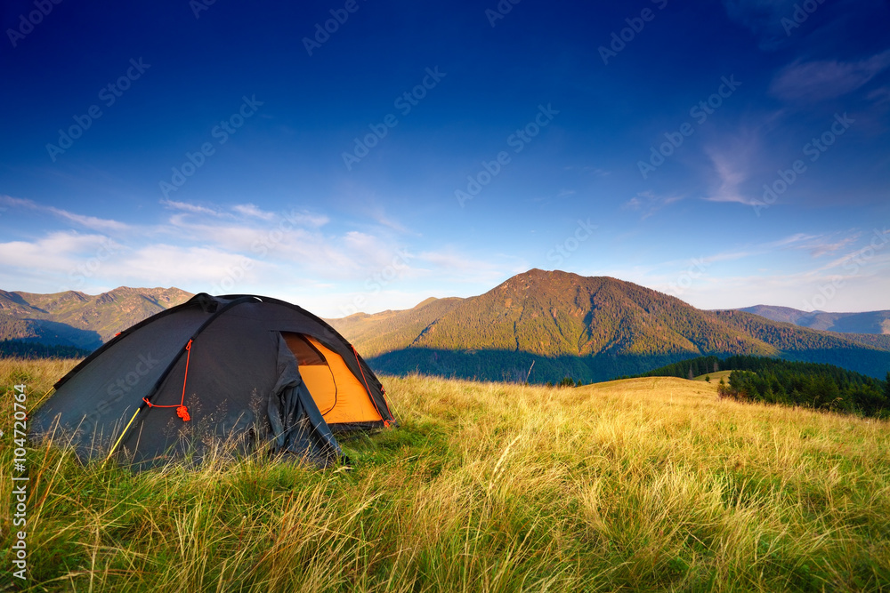 camping tent on the mountain meadow