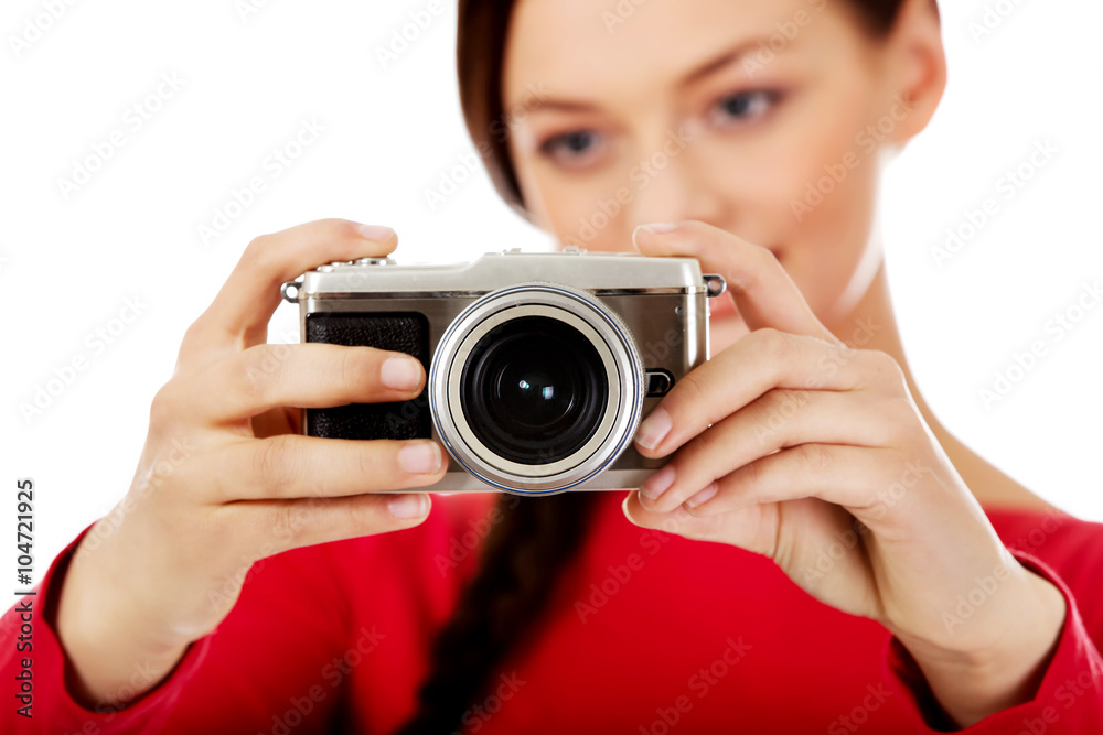 Pretty woman taking a photo using classic slr camera Pretty woman taking a photo using classic slr camera