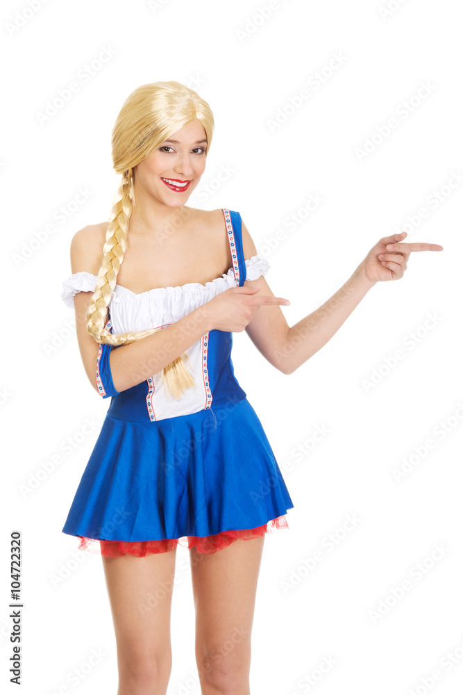 Woman in Bavarian dress pointing aside. Woman in Bavarian dress pointing aside.