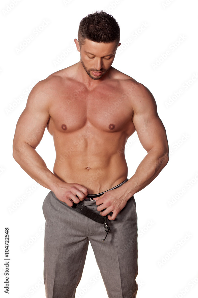 naked muscular man unbuttoning his pants