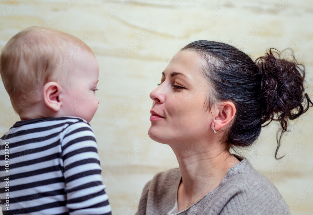 Beautiful mother talking to curious infant Beautiful mother talking to curious infant