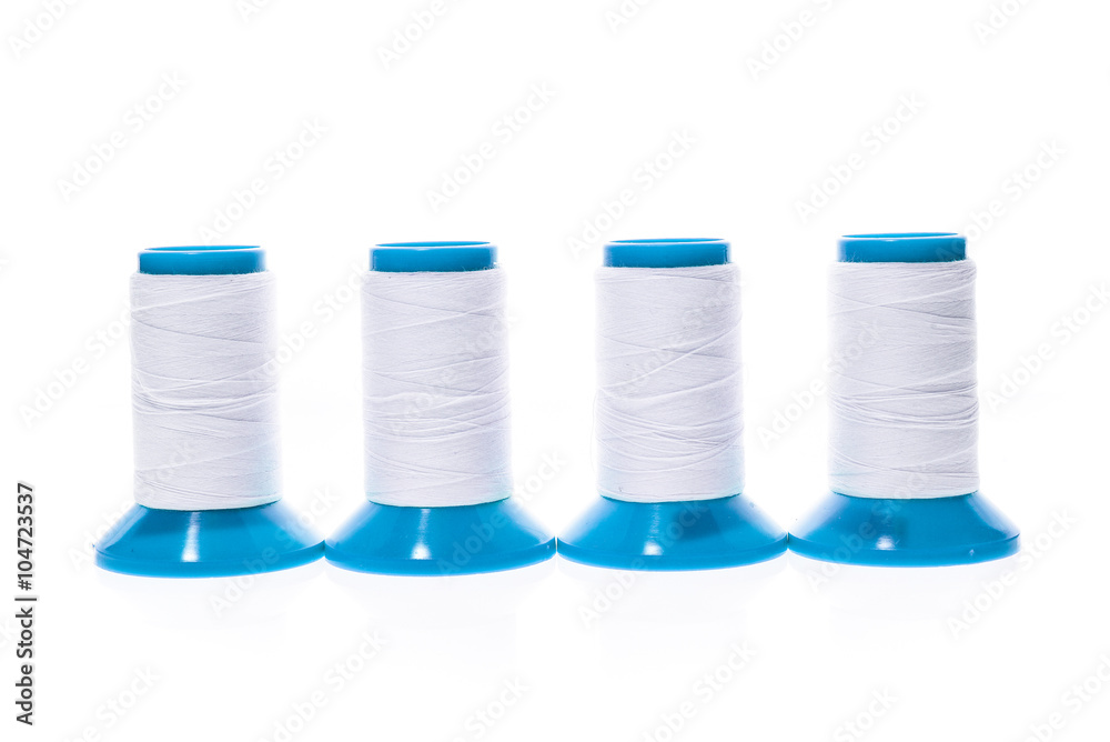 Professional sewing threads on a blue industrial roll. Professional sewing threads on a blue industrial roll.