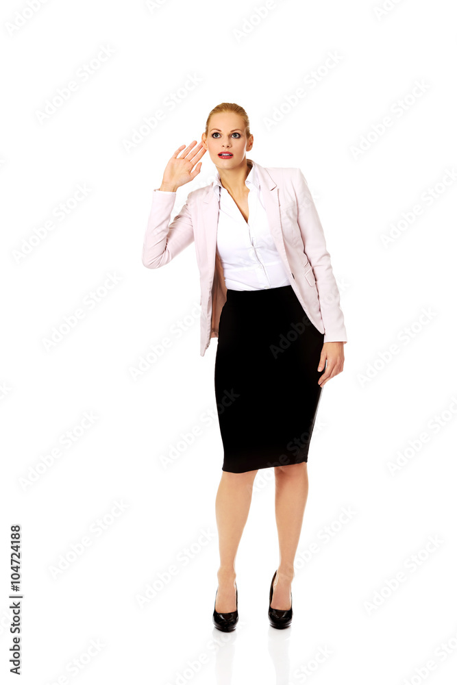 Young woman overhears conversation and laughing Young woman overhears conversation and laughing