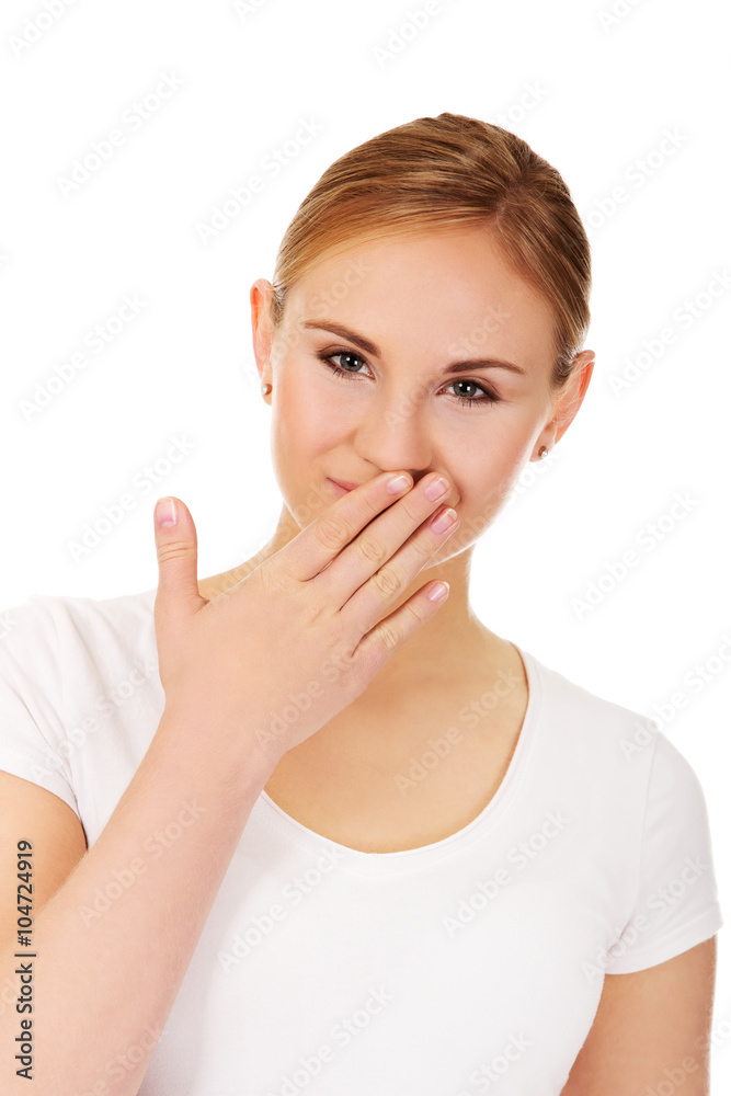 Giggles young woman covering her mouth with hand Giggles young woman covering her mouth with hand