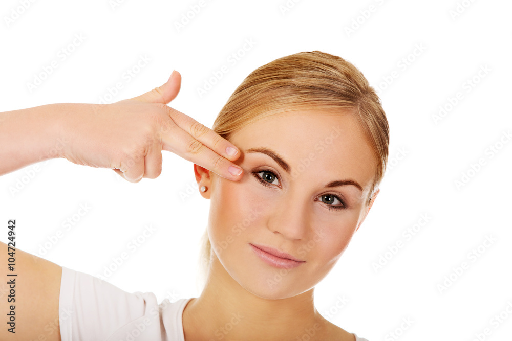 Young woman committing suicide with finger gun gesture