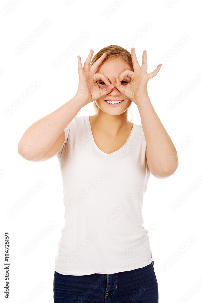 Young woman making binoculars hands Young woman making binoculars hands