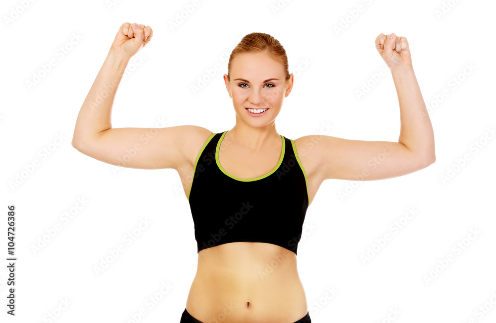 Young athletic woman showing muscles Young athletic woman showing muscles