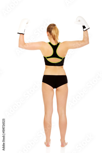 Back view of boxing fitness woman wearing white boxing gloves