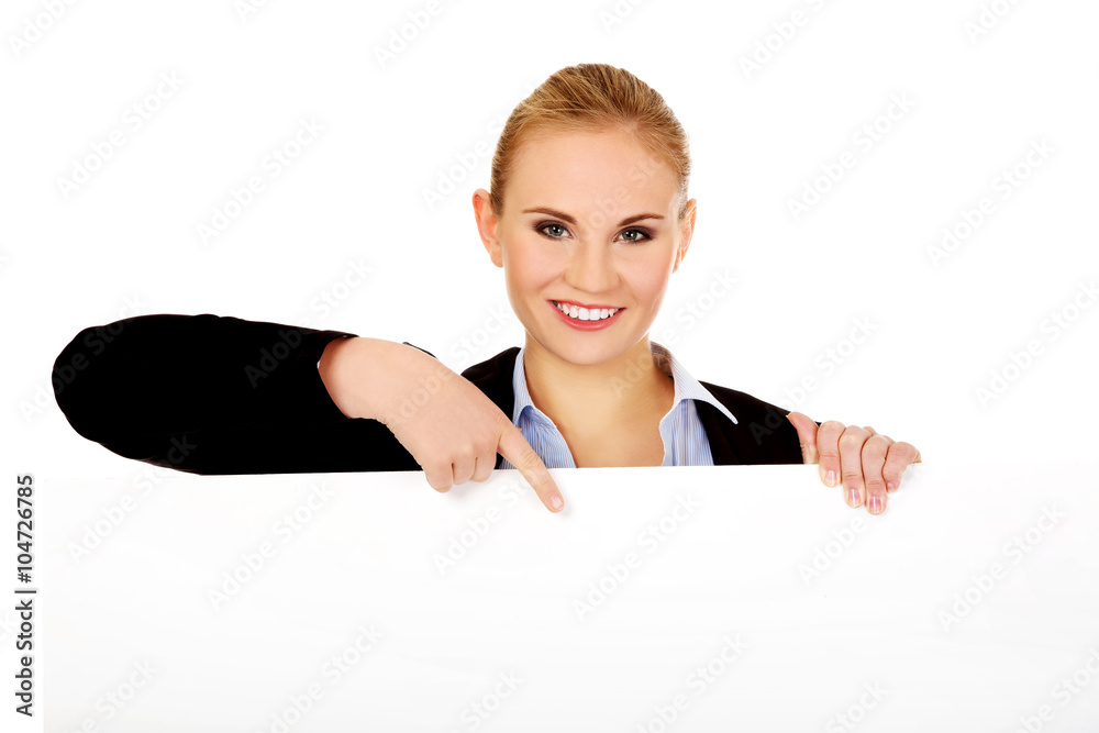 Smiling young businesswoman holding blank banner Smiling young businesswoman holding blank banner
