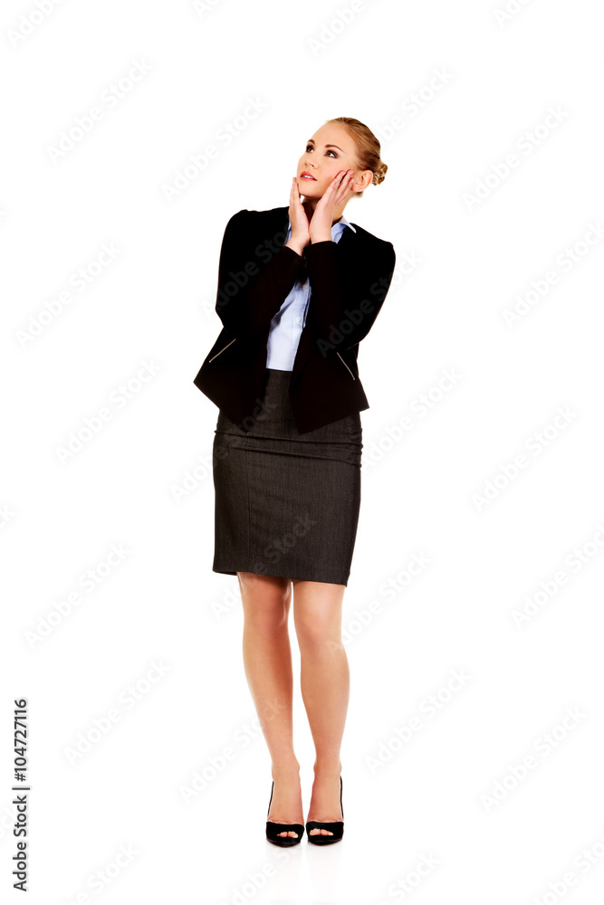 Young worried business woman looking up Young worried business woman looking up