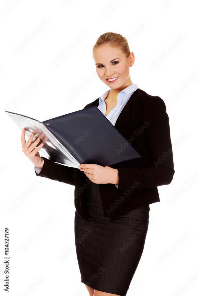 Thoughtful focused businesswoman reading her notes Thoughtful focused businesswoman reading her notes