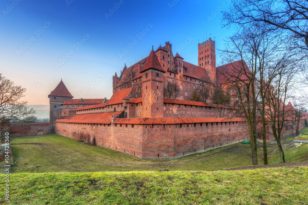 The Castle of the Teutonic Order in Malbork at sunset, Poland