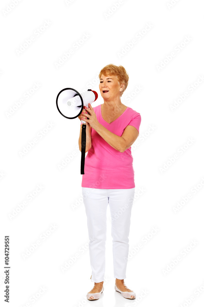 Senior smiling woman screaming through a megaphone Senior smiling woman screaming through a megaphone