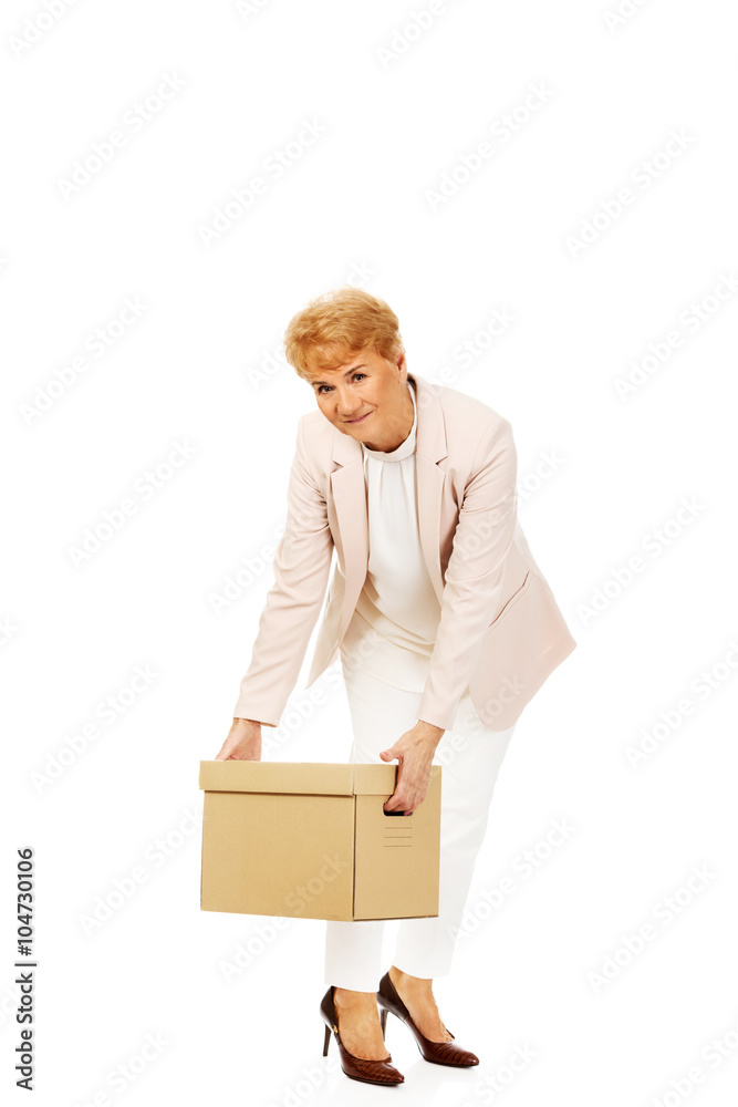 Smile elderly business woman holding cardboard box Smile elderly business woman holding cardboard box