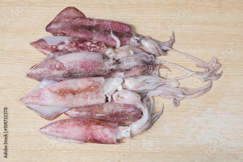 Group of squid on wooden table