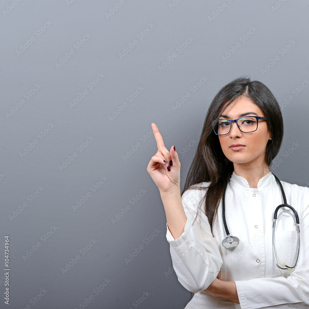 Young beautiful female doctor showing blank area Young beautiful female doctor showing blank area