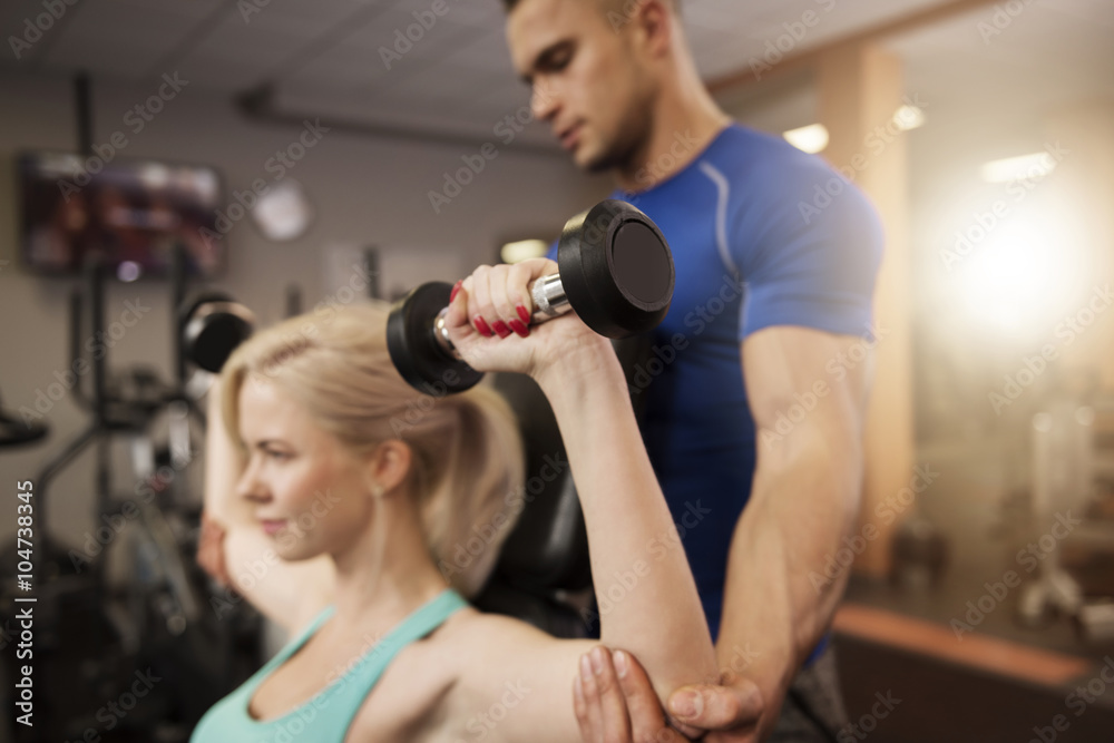 Shoulder press with a personal trainer Shoulder press with a personal trainer