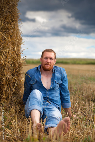  Man in jeans  on  field. © DariaTrofimova