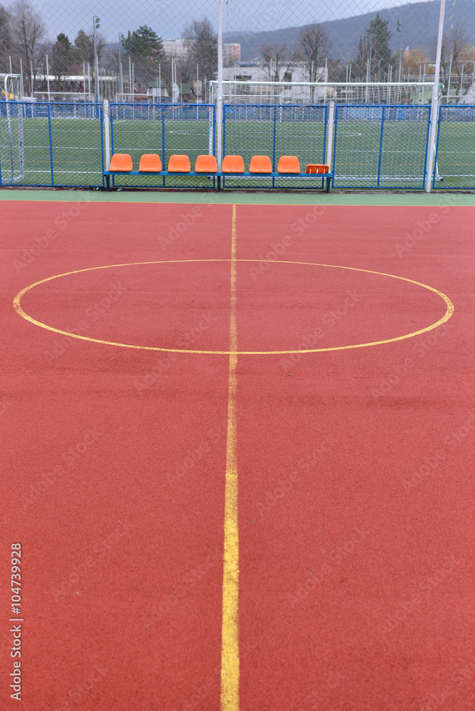 Fototapeta premium Soccer field made from red granule rubber. Football field backgr