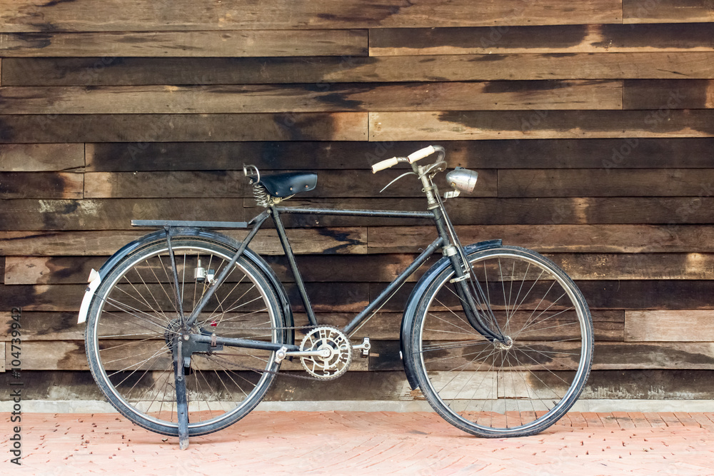 Vintage rusted racing bicycle parked in an old factory with wood