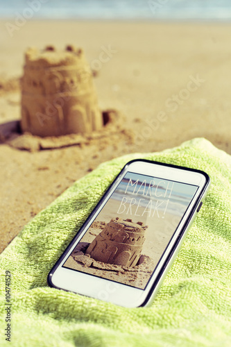 picture of a sandcastle and text march break in a smartphone