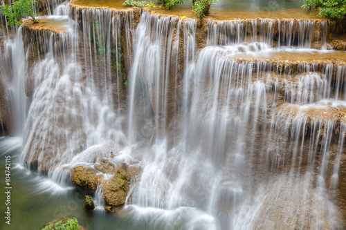 Water flowing over rocks in Huai Mae Khamin waterfall cascade in a forest. © Southtownboy Studio